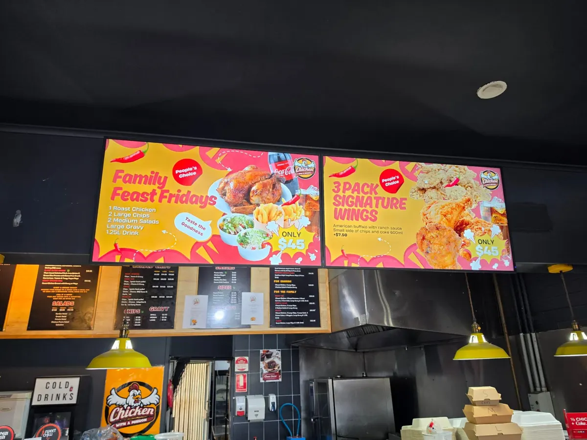 Digital menu boards at a chicken takeaway